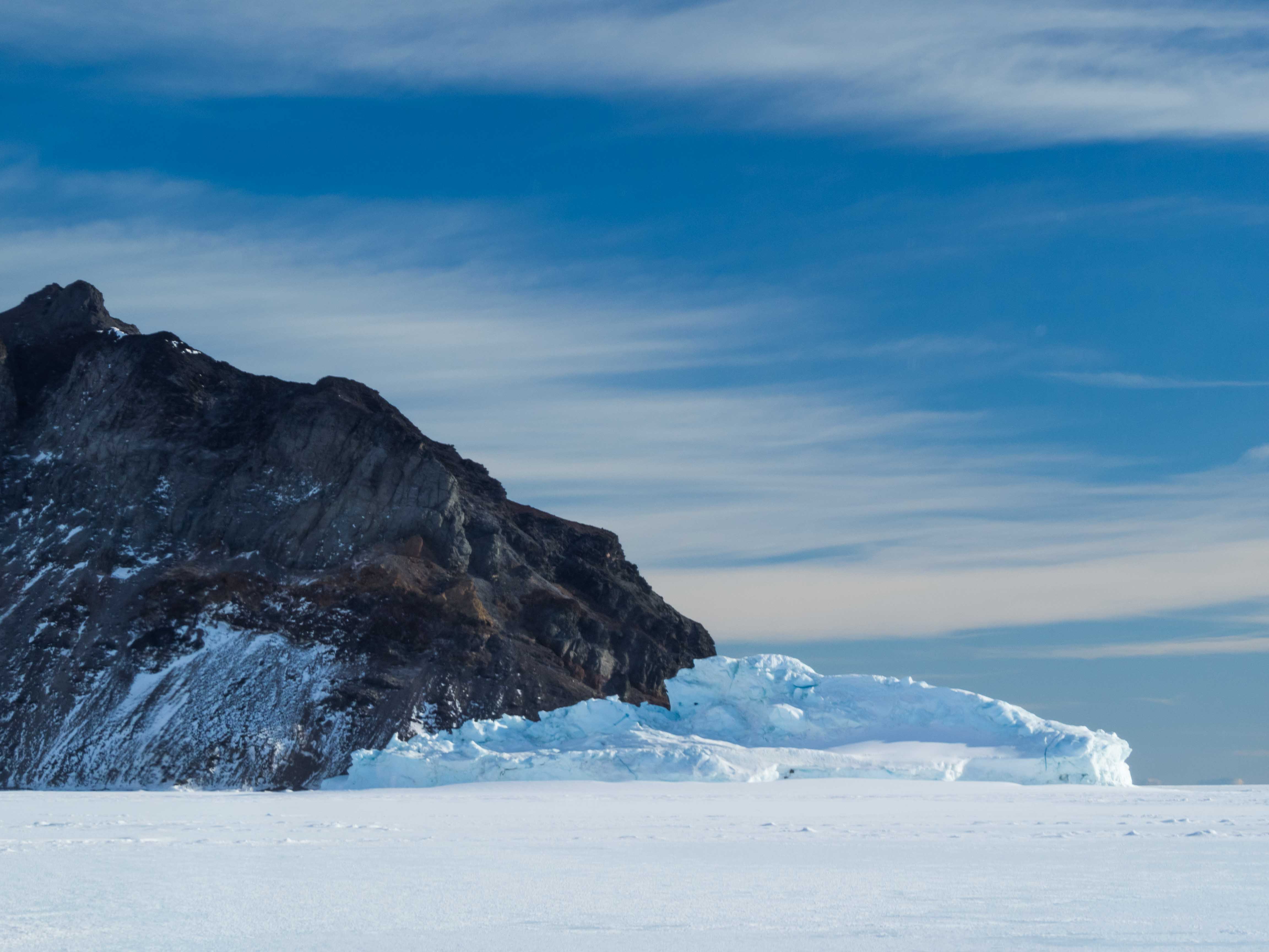 Iceberg on the frozen sea ice