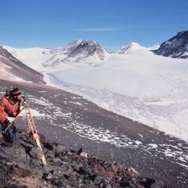 Lawrie Cairns surveying movement poles, Jeremy Sykes Glacier