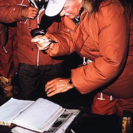 Sir Arthur Espie Porritt, Governor General of NZ signs the visitors book at the Cape Evans hut