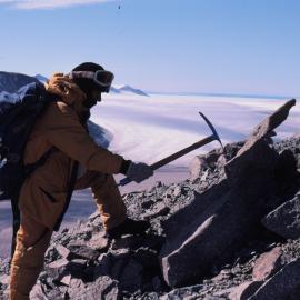 Peruvian guest scientist, Riednes Gomero, examines a rock outcrop on Robertson Ridge