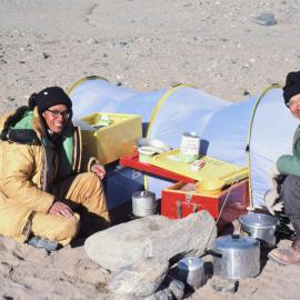 Chinese guest scientists, Zhang Fu Yuan and Chen Ting Yu, cooking dinner at the Robertson Ridge Camp