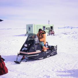 Lord Shackleton on a toboggan outside a fish hut