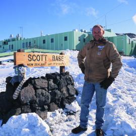 Fred Parsons, Scott Base Mechanic 98-99 Season with stuffed sheep at the Scott Base sign
