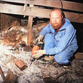 Roger Fyfe of the Antarctic Heritage Trust in the Stables at Cape Evans