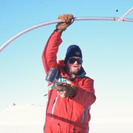 Kevin Nicholas erecting a Polar Haven tent for the Turtle Rock science project