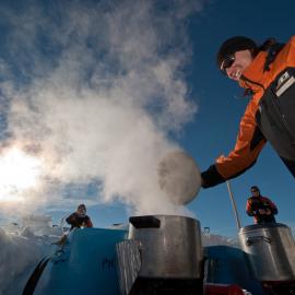 Melting snow for dinner and a cuppa in a field kitchen