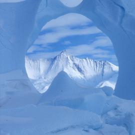 Mt Herschel seen though iceberg near Cape Hallett camp