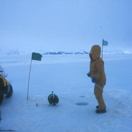 Plankton sampling through sea ice hole near Cape Hallett camp