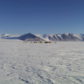 Tent in the landscape, with Mt Erebus in the background