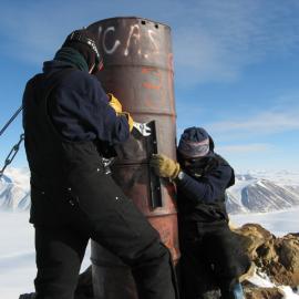 Nic Donnelly and Ian Whiteley attempting to unbolt the drum beacon on the Ridge above Herbertson Glacier