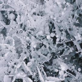 Ice cracks and air bubbles in a pond