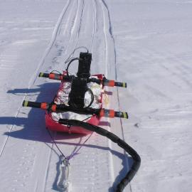 Close up of empty sled showing red plastic construction and black crossbars