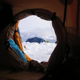 View from inside a polar tent looking out to a blue dome tent