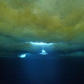 Two penguins diving under the water through a hole in the ice