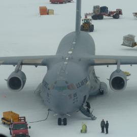 Looking down on a busy airfield: C-17 and various vehicles