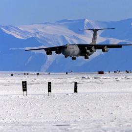 A United States C-141 Starlifter landing on the sea ice in front of McMurdo Station
