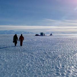 Seal scientists returning to camp over sea ice near Huttons Cliffs