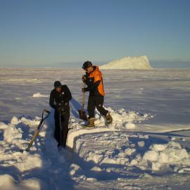 Digging preparatory to drilling an ice crack to check for safe driving conditions