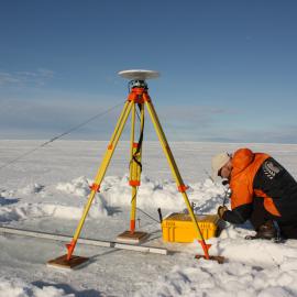 Securing high-precision GPS equipment for tide gauge calibration at Cape Roberts.