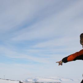 Natalie Miedema, 2010 Antarctic Youth Ambassador, points to the wind farm from Arrival Heights