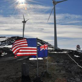US and NZ flags and wind turbines