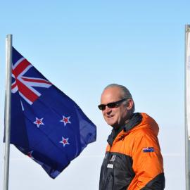 Board chairman Rob Fenwick between the NZ and US flags, speaks at the ceremony for the wind farm commissioning