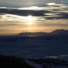 Shrouded Sun over Mountains and Ice