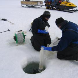 Kathy Ruggiero and Mary Sewell sampling at the plankton hole