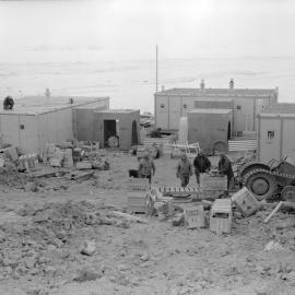 Beginning the construction of Scott Base showing F, D, and C Huts and the start of the covered way