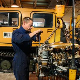 Mechanic at work, with Hägglunds nearby