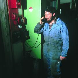 Logan McGlure (?) at internal telephone, garage