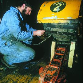 Logan McGlure repairing snow tractor