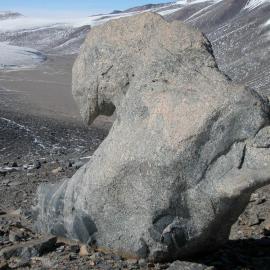 Sculpture of weathered granite with Victoria Lower Glacier in background