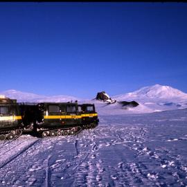 Two hagglunds with Castle Rock and Erebus