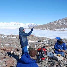 Collecting data in the field close to Lake Wellman.