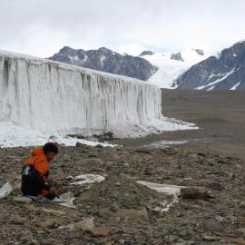 Peter Almond taking soil samples from a pit near Howard Glacier, eastern Taylor Valley.