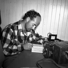 Derrick Wright keeping diary in Malte Brun hut