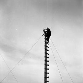 Dr Ron Balham climbing the anemometer mast