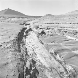 Gullied stream bed in frozen sand dune north of lake Vida