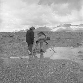 Dr Ron Balham and P. Webb examine a shallow pool 