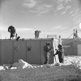 Brushing snow from roof