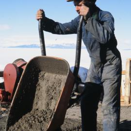 Ron Garrick Pouring Concrete in front of the Hangar