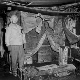Eric Gibbs Stands Beside an Old Brick Stove