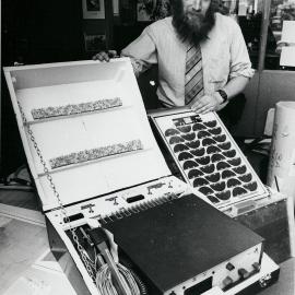 Garth Varcoe with solar cells for charging radio batteries