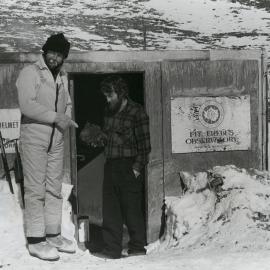 Graeme Blick and B Scott with lava bomb at Erebus Hut