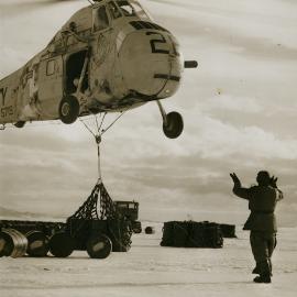 Helicopter lifts drummed fuel oil from sea ice 'dock' 