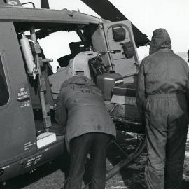 Loading a motor toboggan into a Navy UH-1N helicopter
