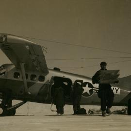 Field party receiving supplies from Navy UC-1 Otter 