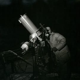 John Elder, senior scientist at Scott Base, makes adjustments to the 10 inch Cassegrain telescope during winter