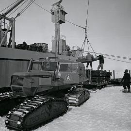 Loading a sno-cat with building materials